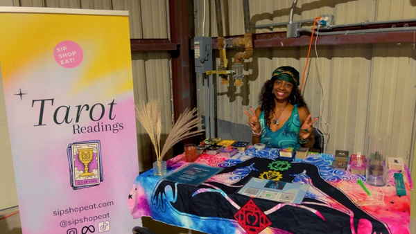 A psychic for an event booking, sitting at her setup table | Altus Entertainment